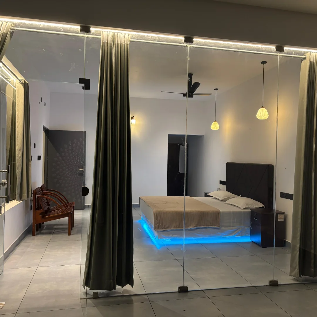 Bedroom viewed through floor-to-ceiling glass wall